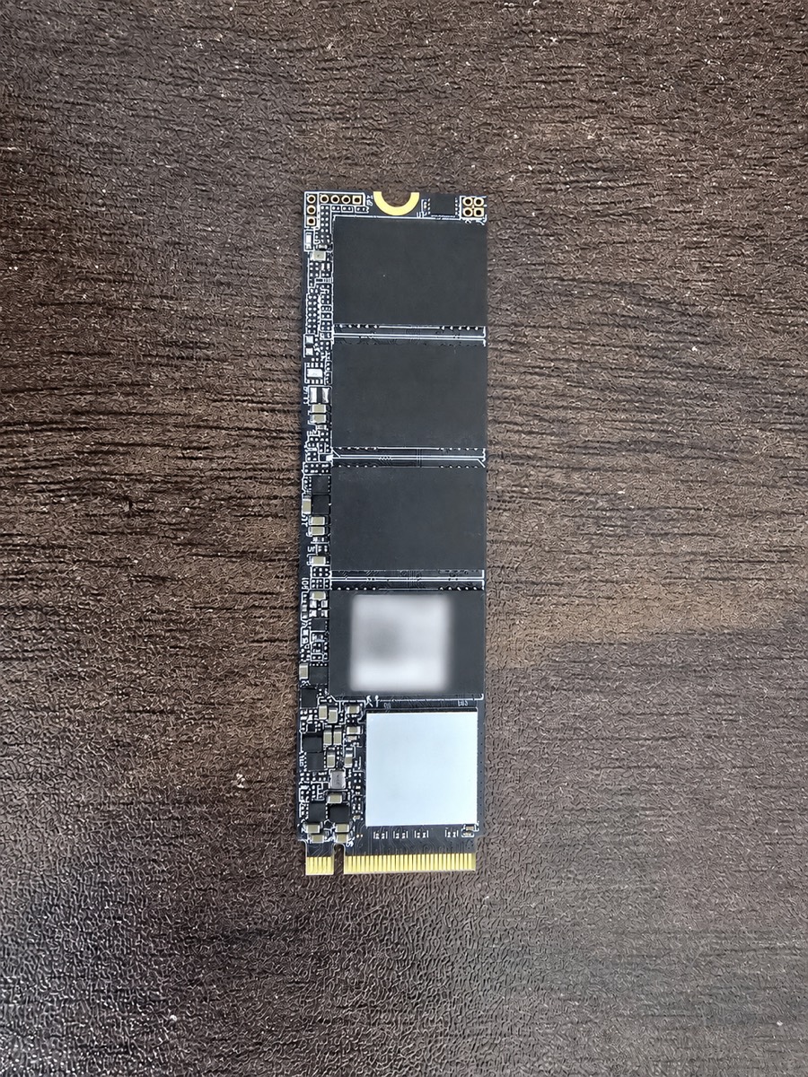 A bare NVMe SSD with its identifying label and QR data obscured